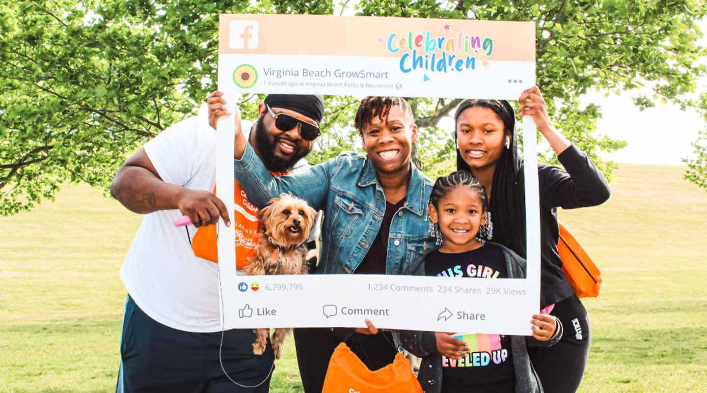 Family with signage at Celebrating Children