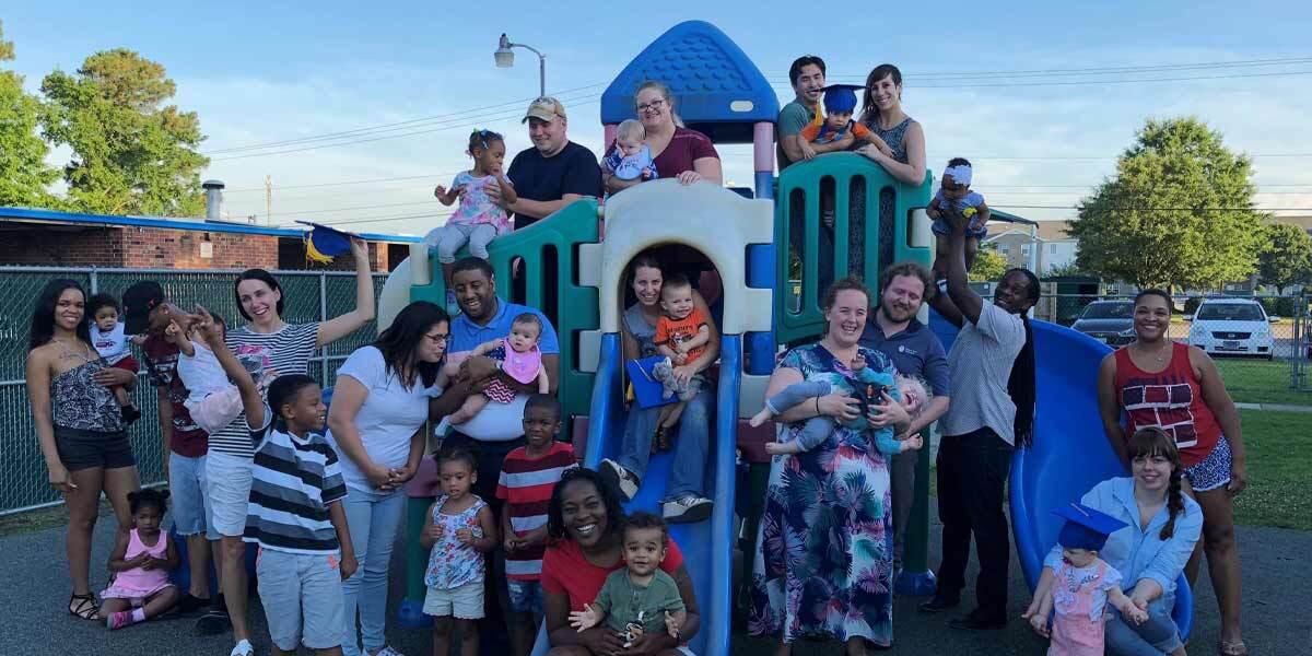 Parents and Children on a Playground Posing for Picture