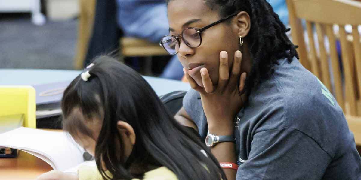 Volunteer Helping Child Read