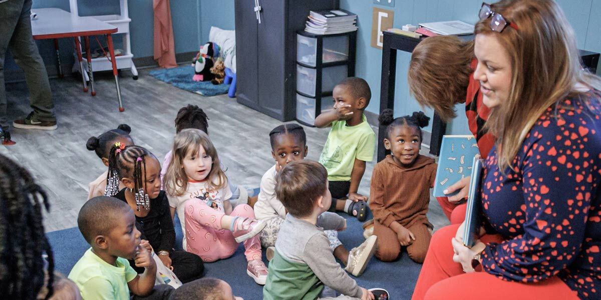 Volunteer Reading a Book to Children