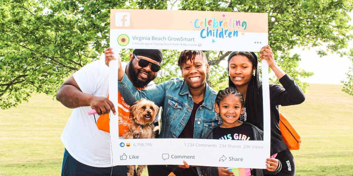 Family posing for a picture at celebrating children 1200x600
