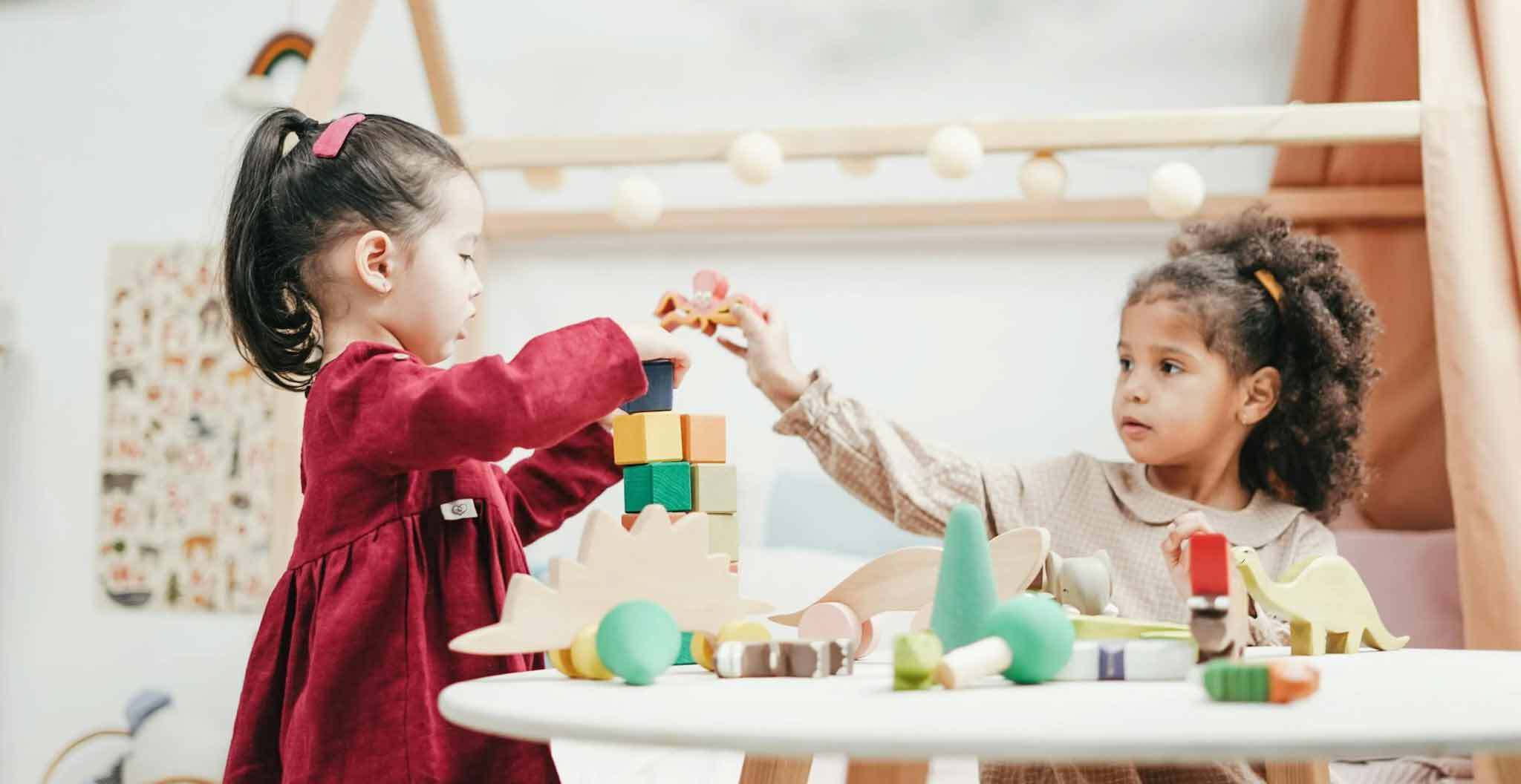 Girls Playing with Blocks on Table