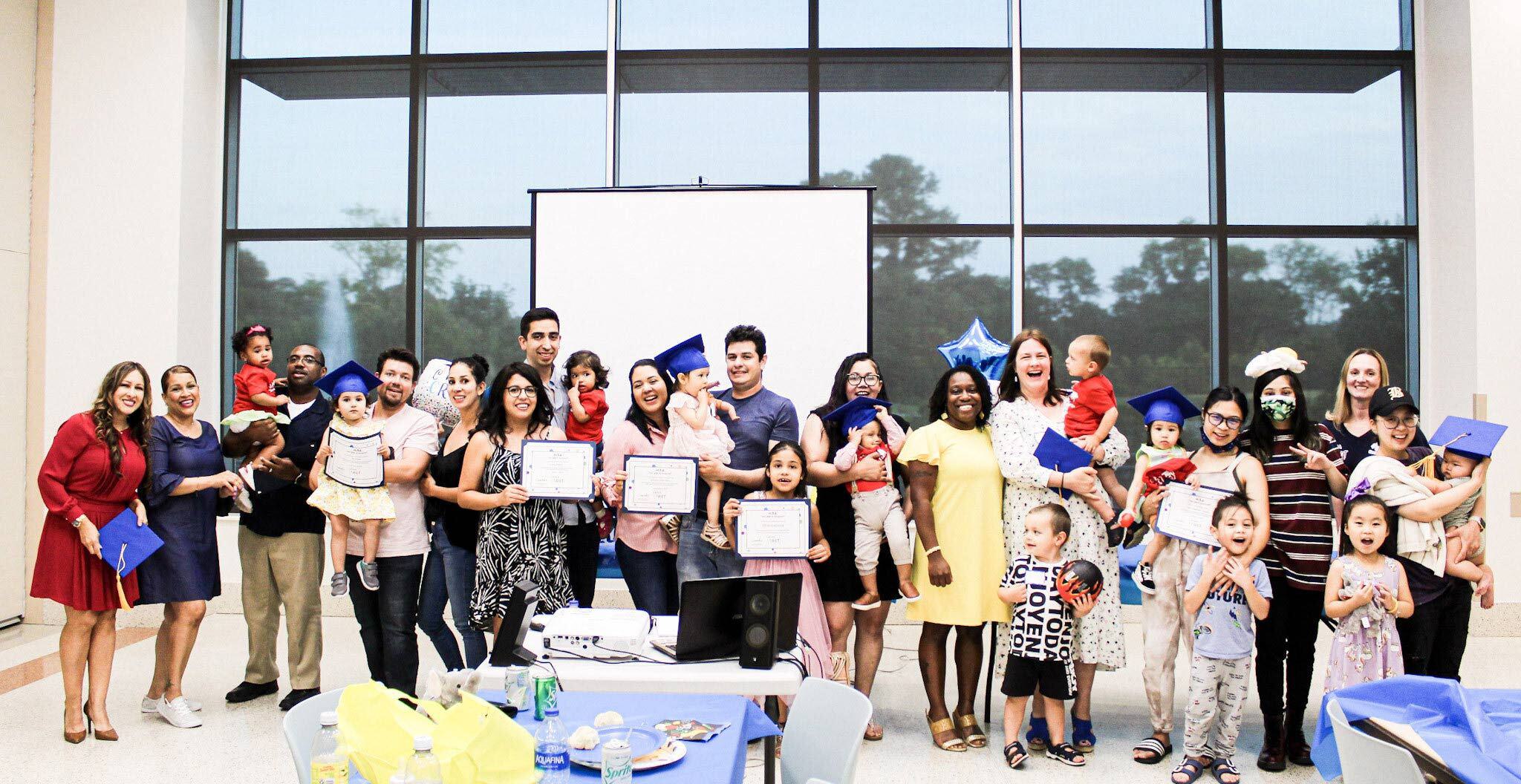 Lena Graduates Holding Children and Certificates