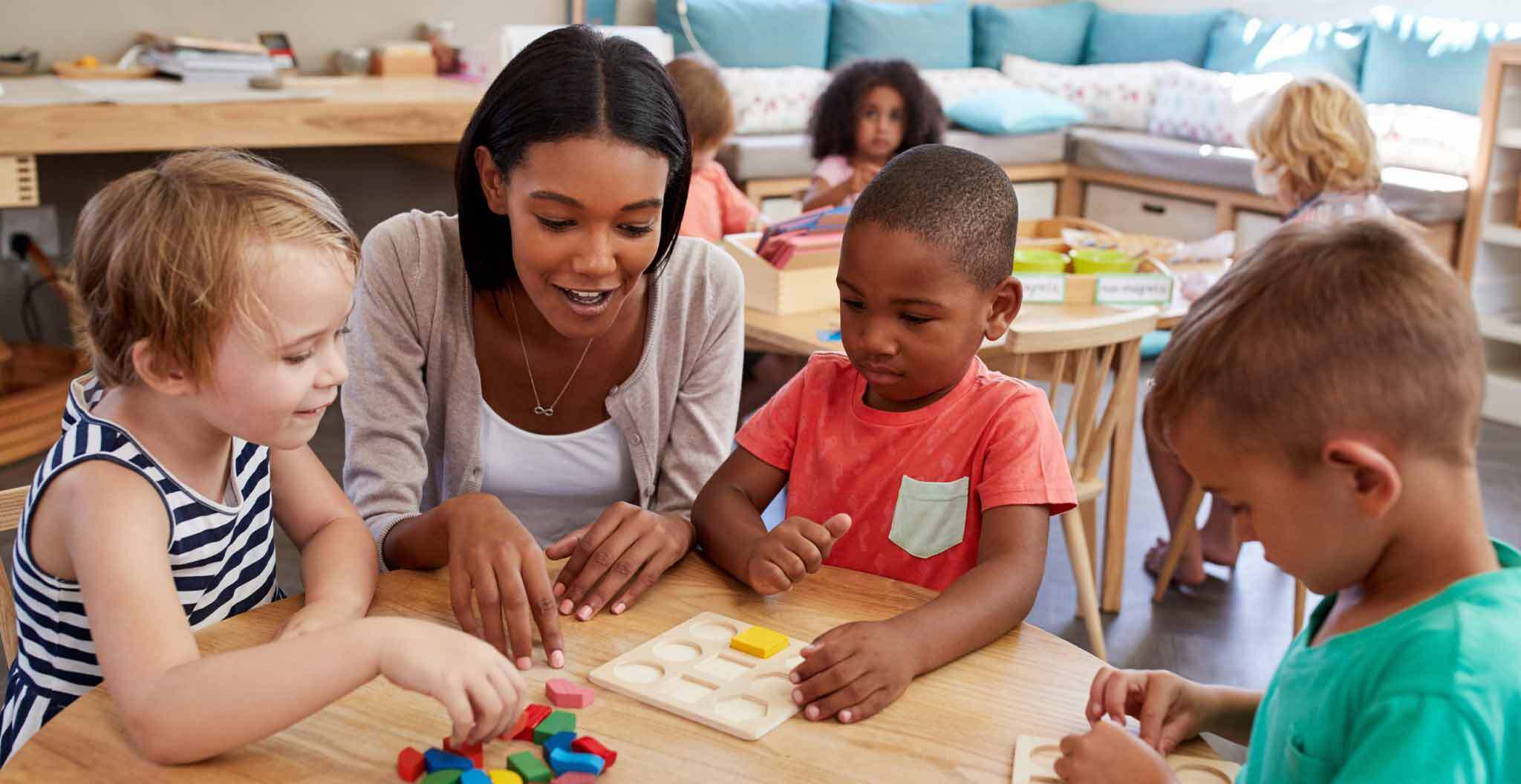 Teacher Playing with Children and Blocks